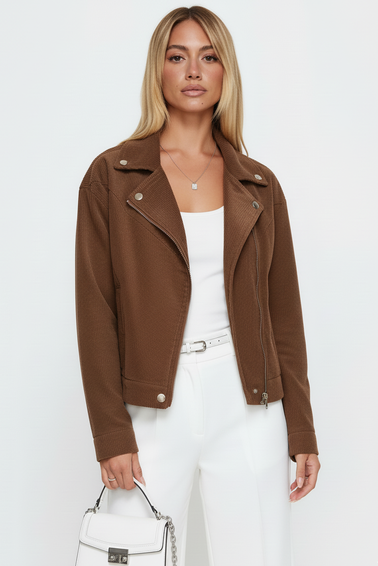Woman wearing a brown jacket over a white outfit on a white background